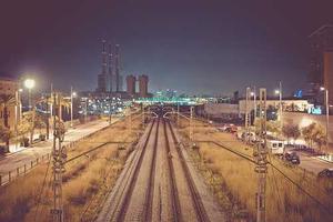 Wooden pier extending over calm water with weathered planks and rope railings
